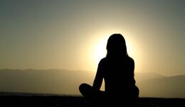 Mindful Birthing Woman Meditating at Sunset